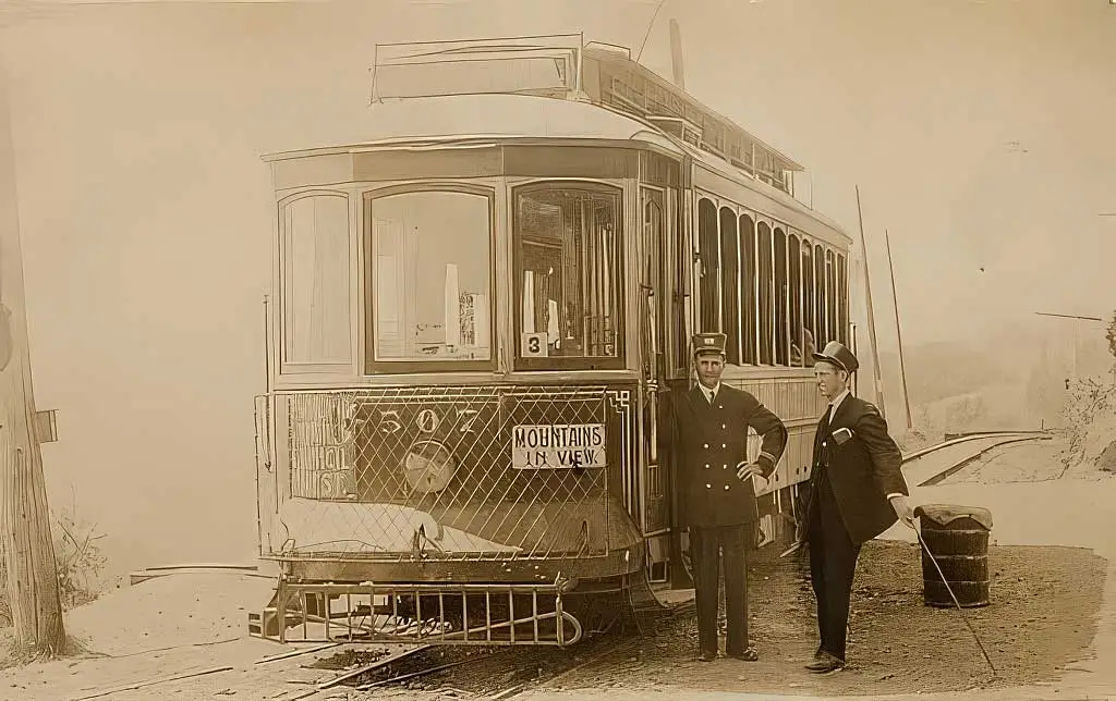 historic photo of portland's streetcar and two conductors from the late 1800s.