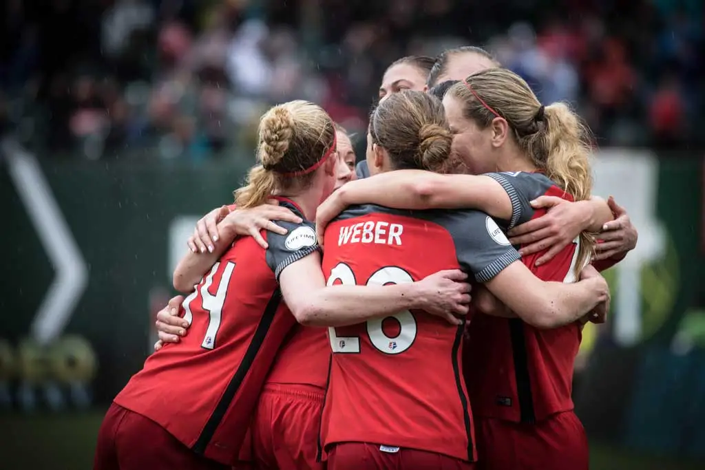 Portland Thorns soccer players celebrating on the field
